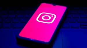 A person checking an Instagram profile on a phone and noticing it is unavailable.