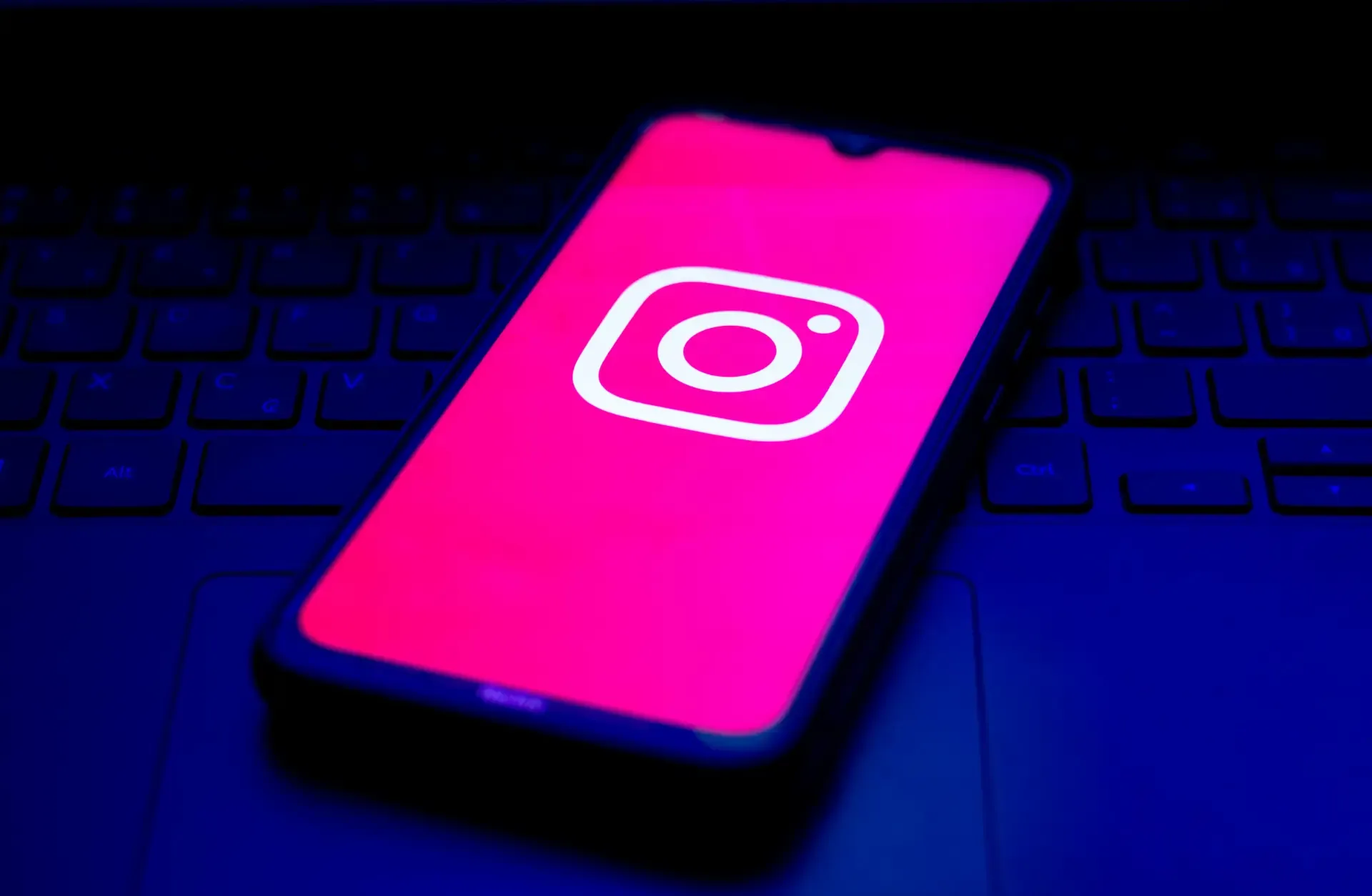 A person checking an Instagram profile on a phone and noticing it is unavailable.